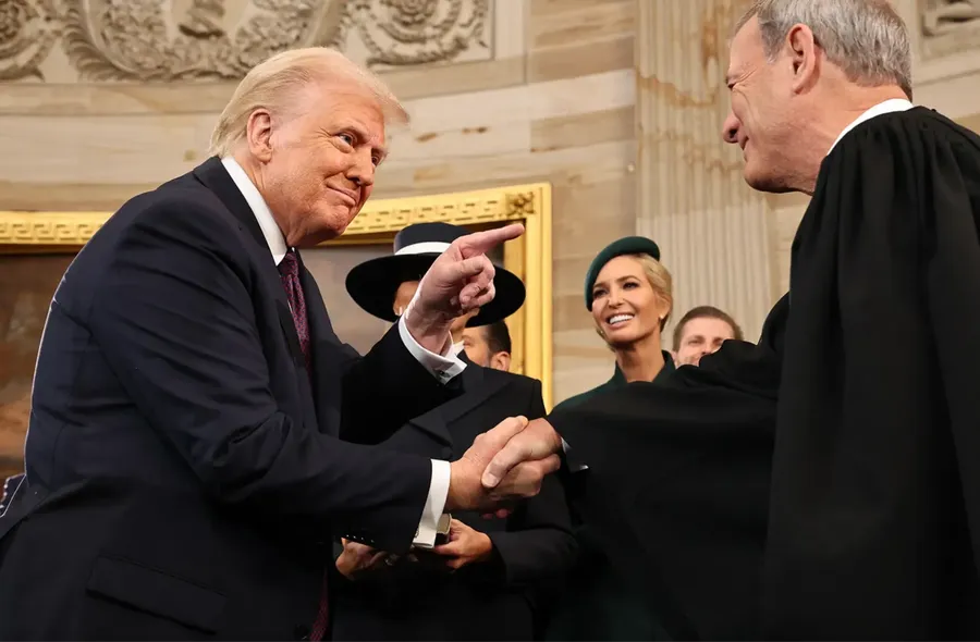 U.S. President Donald Trump shakes hands with Supreme Court Chief Justice John Roberts
